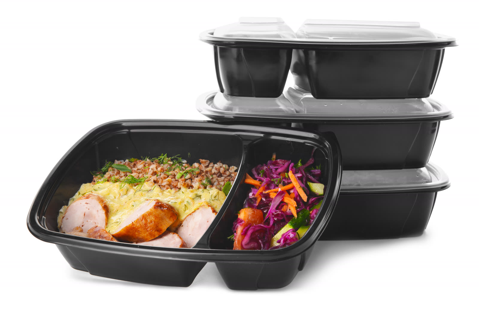 Black two-compartment container filled with chicken and slaw beside a closed stack